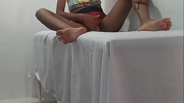 A beautiful brunette massage therapist waits for a client to arrive in her office. She moans while making movements, showing her buttocks and breasts.